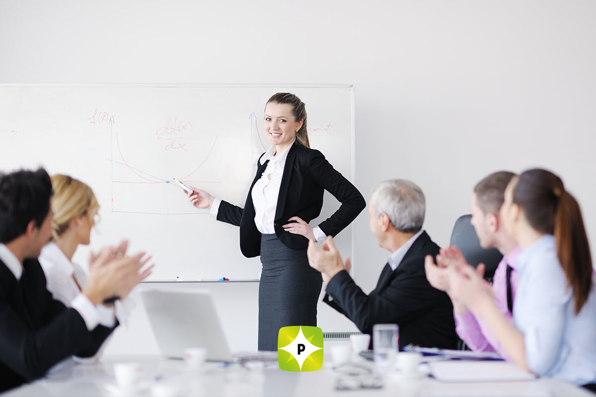 Woman in a meeting room in front of a whiteboard with math formulas and graphs, representing Cargo Cult Six Sigma