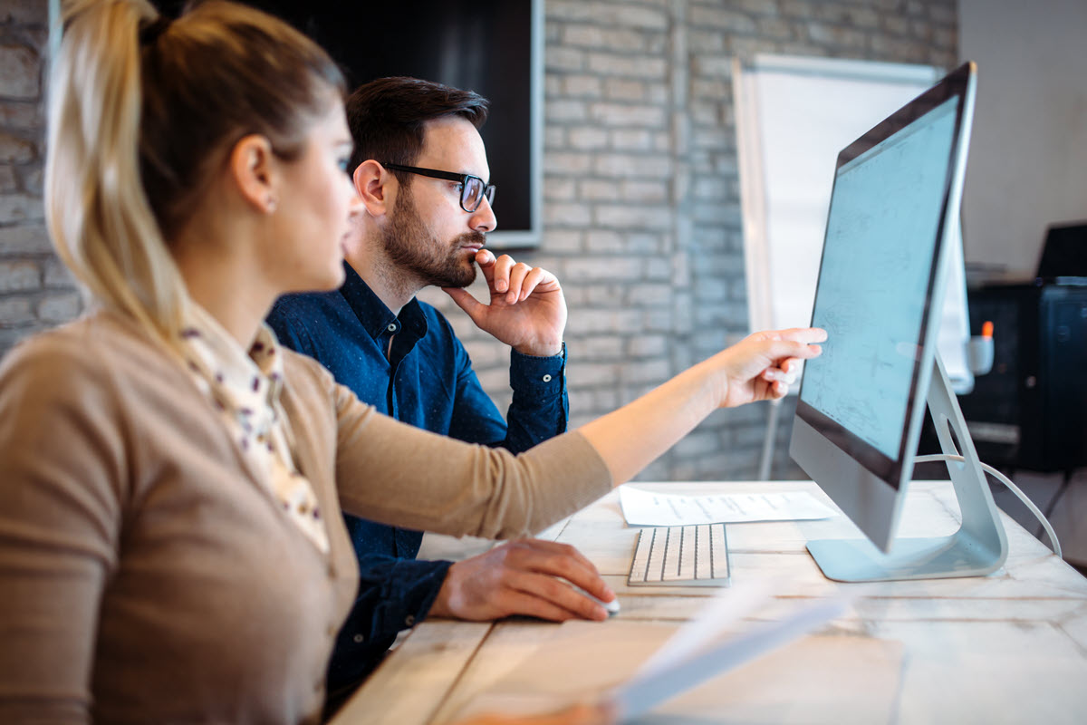 Two people working on a desktop