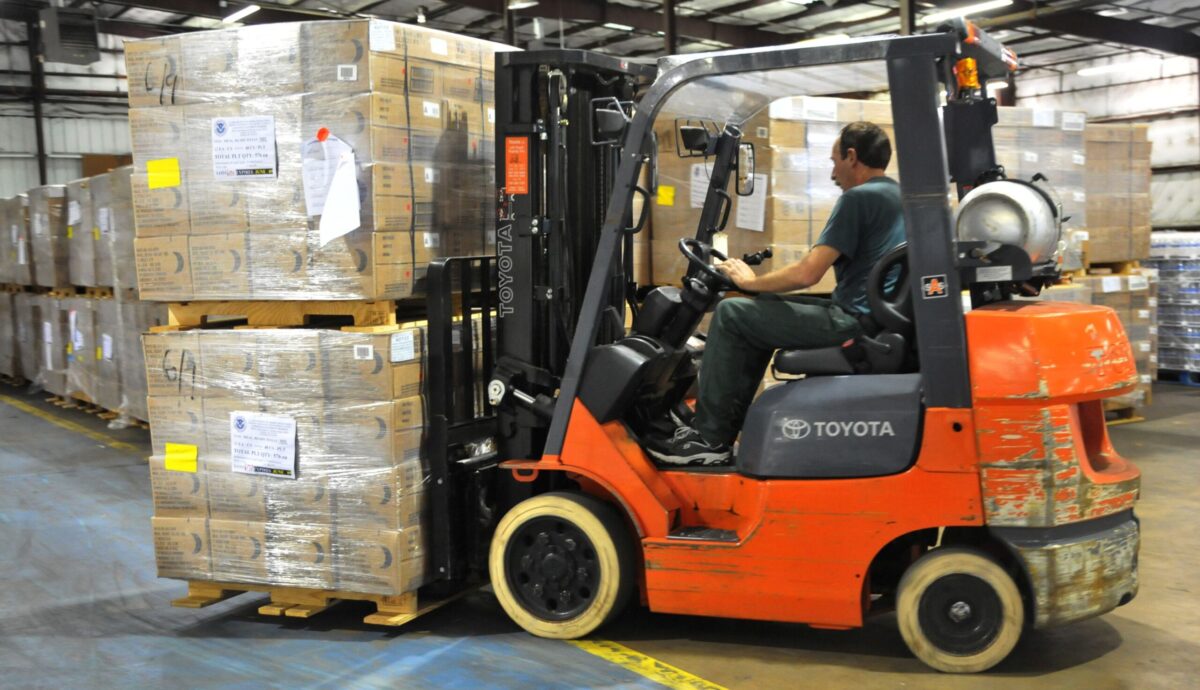 Forklift moving pallets in warehouse